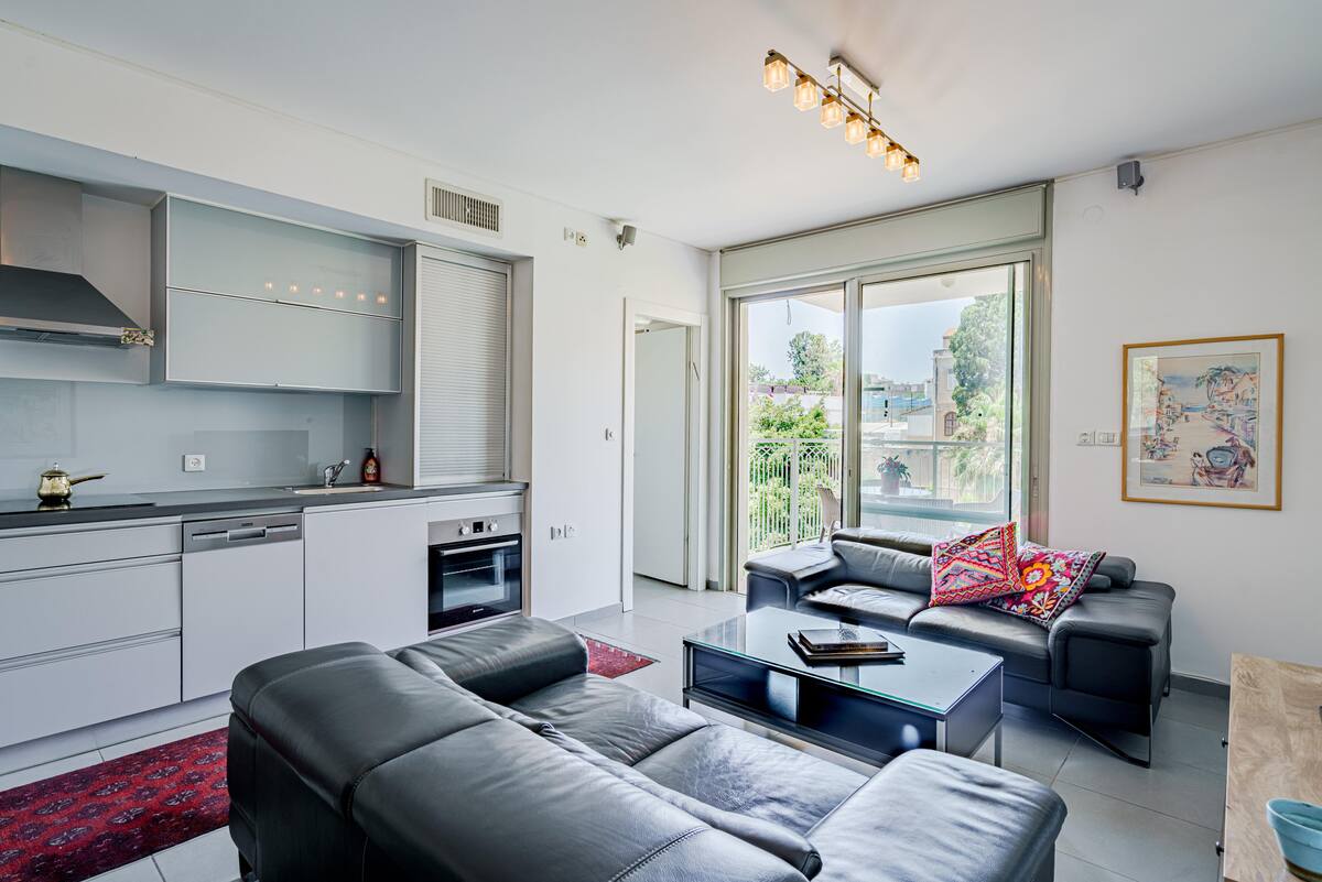 Harova Apartment Jaffa – open-plan living room with kitchen and balcony
